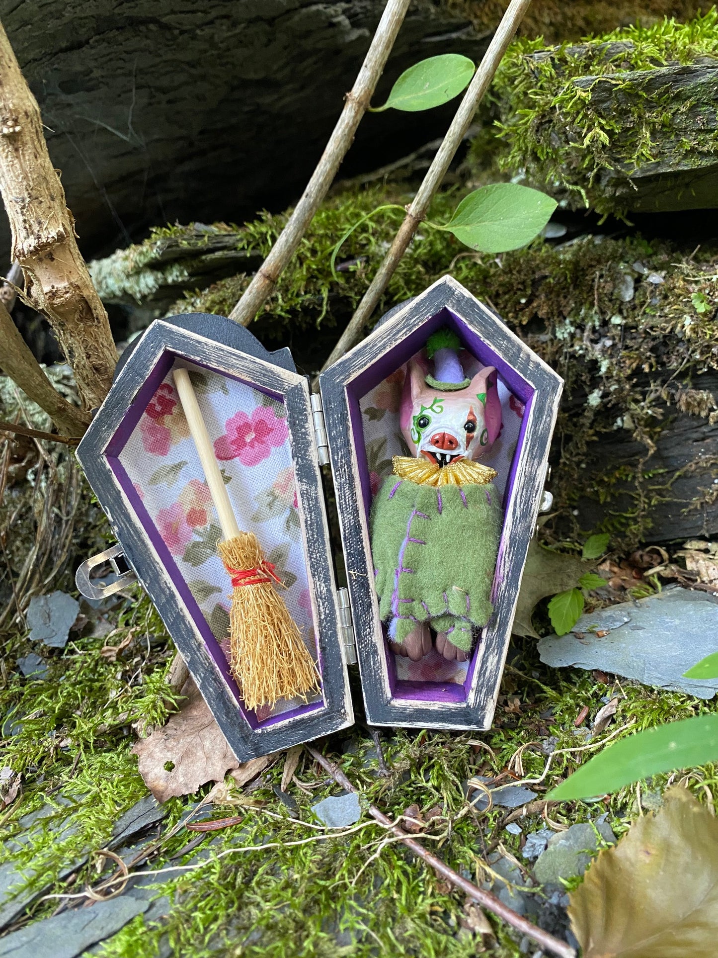 Clown witch hanging bat with coffin